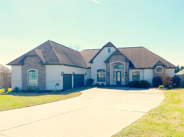 french country inspired facade with a garage and a lawn