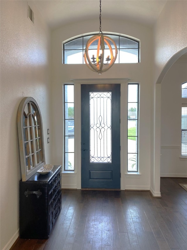 foyer entrance featuring dark hardwood / wood-style floors and an inviting chandelier