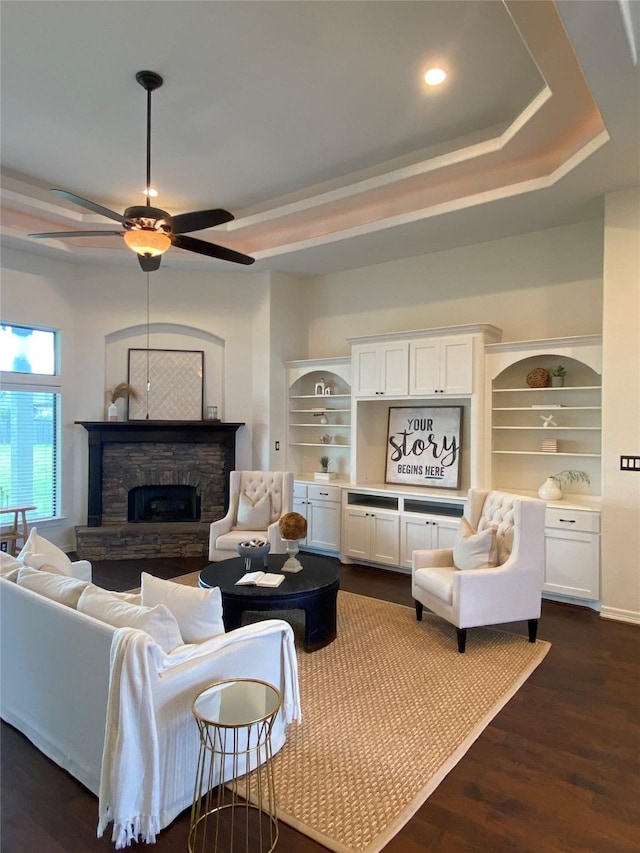 11707 W Grand Pond Dr, Montgomery, TX 77356 - living room featuring a fireplace, dark wood finished floors, a tray ceiling, a ceiling fan, and recessed lighting