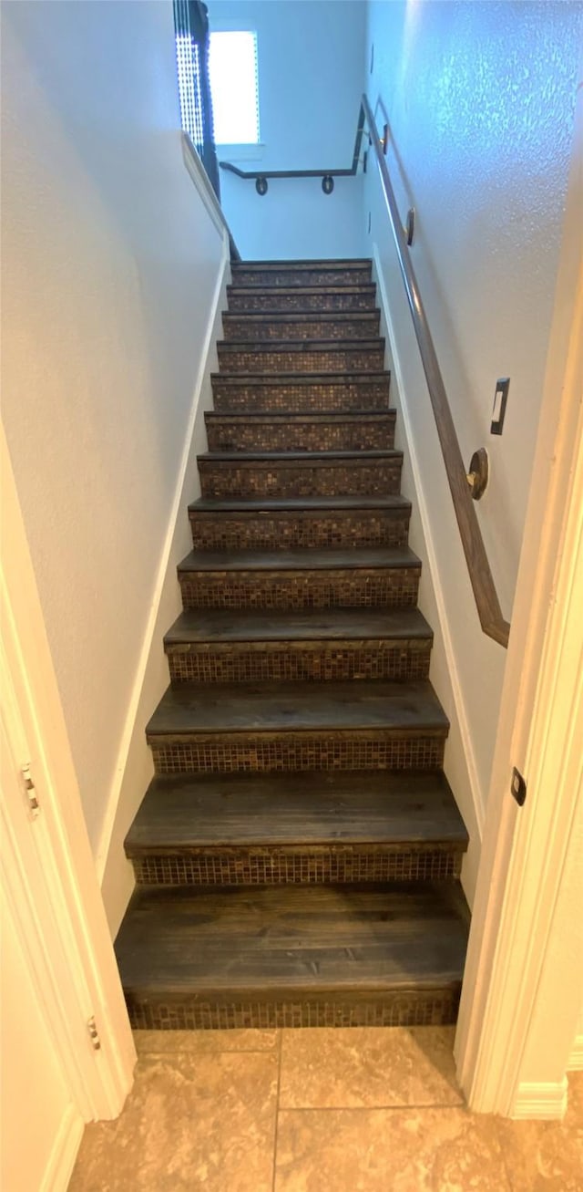 stairs featuring tile patterned floors