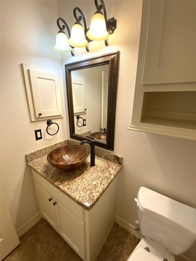 bathroom with vanity, tile patterned flooring, and toilet