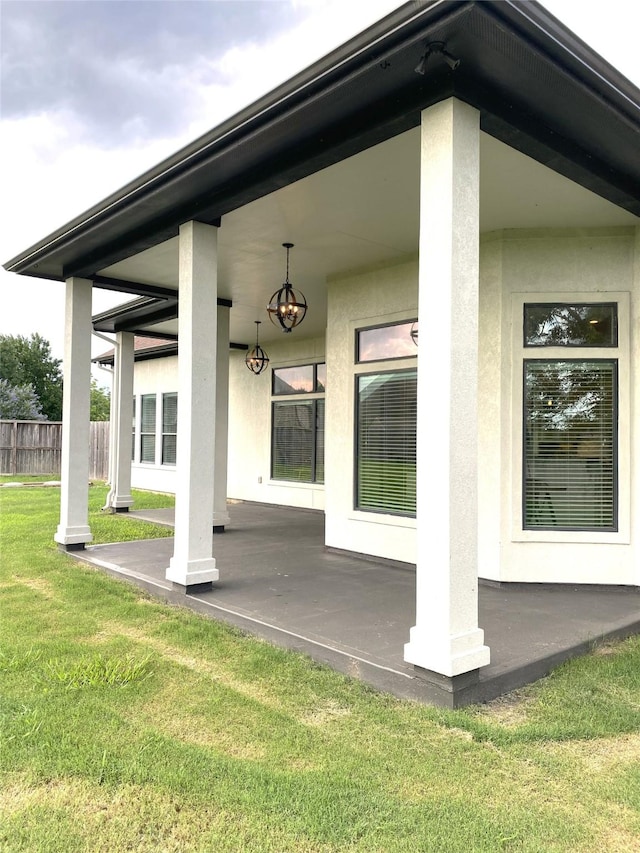 view of exterior entry featuring a lawn