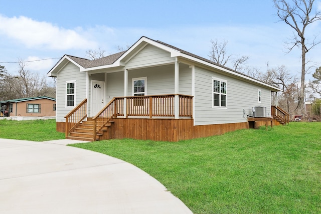 view of front of house featuring a porch, cooling unit, and a front yard