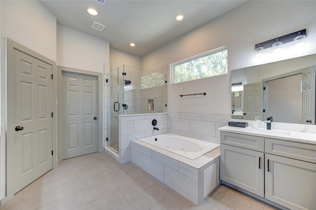 bathroom with tile patterned floors, vanity, and separate shower and tub