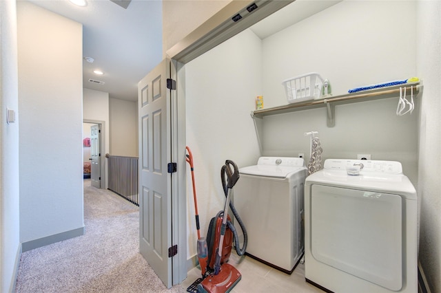 laundry room featuring independent washer and dryer and light colored carpet