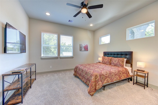 bedroom with ceiling fan and light carpet