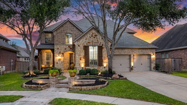 view of front of home featuring a yard and a garage