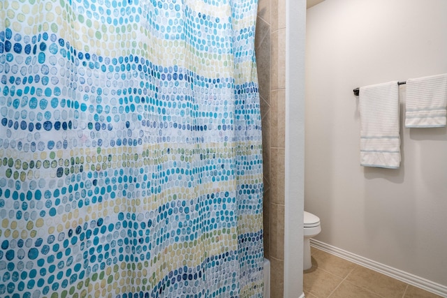 bathroom featuring tile patterned flooring, toilet, and a shower with shower curtain