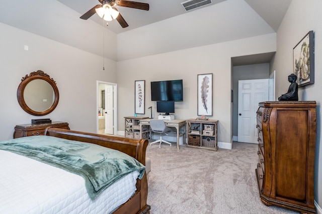 bedroom featuring lofted ceiling, light carpet, connected bathroom, and ceiling fan