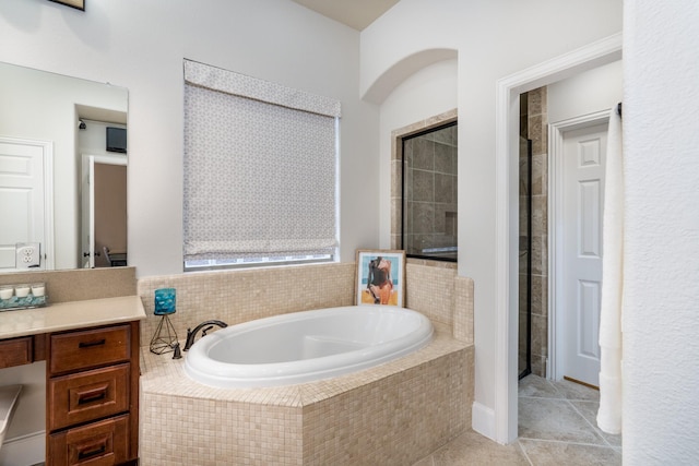 bathroom with tile patterned flooring, vanity, and separate shower and tub