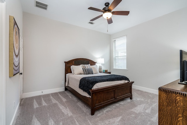 bedroom featuring light carpet and ceiling fan