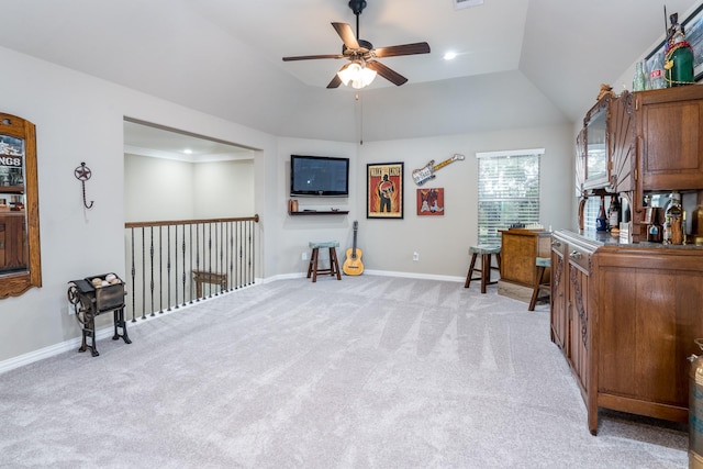 office area with ceiling fan, light colored carpet, and vaulted ceiling