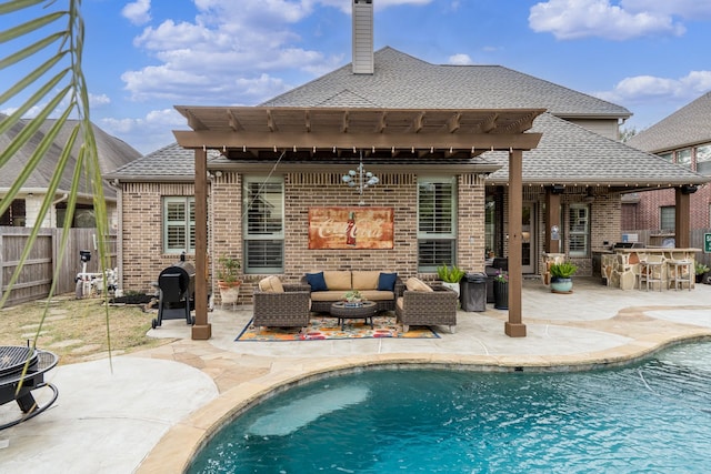 rear view of house with a bar, a patio area, outdoor lounge area, and ceiling fan