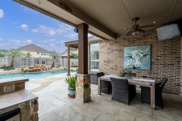 view of patio / terrace featuring a fenced in pool, pool water feature, and ceiling fan