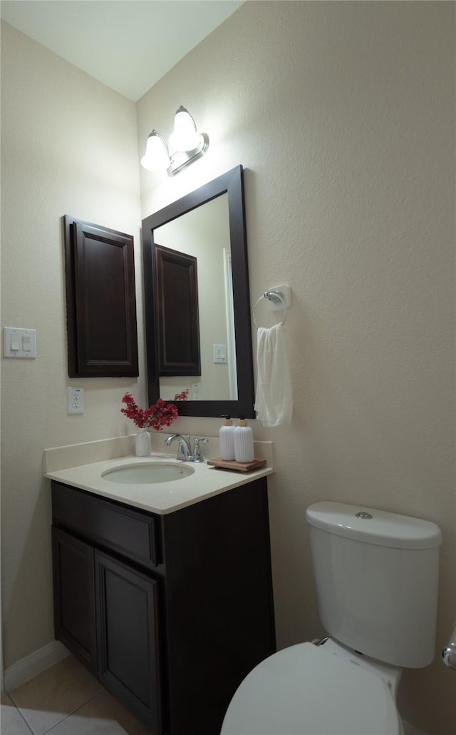 bathroom featuring tile patterned floors, vanity, and toilet