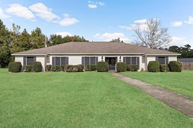 ranch-style home with a front yard