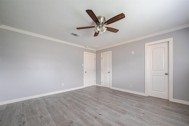 empty room with ornamental molding, light hardwood / wood-style flooring, and ceiling fan