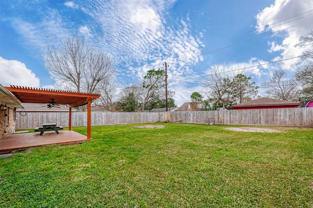 view of yard featuring a deck, a pergola, and ceiling fan