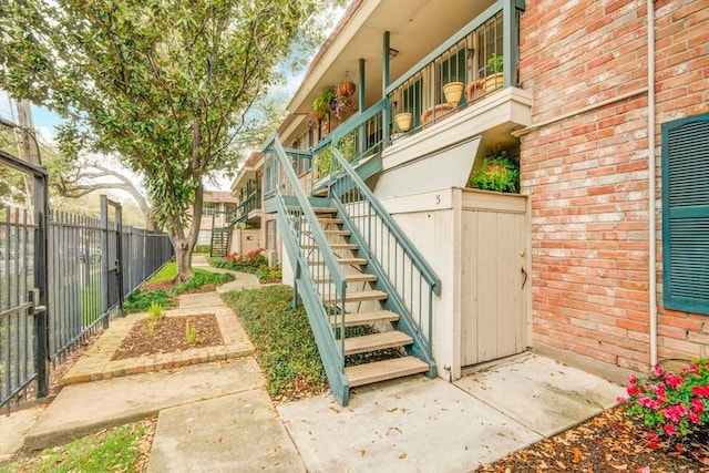 view of property's community featuring stairway and fence