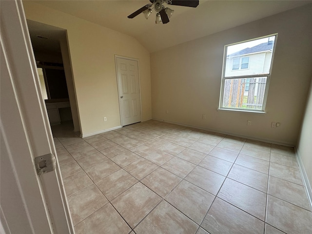 unfurnished bedroom featuring light tile patterned floors, ceiling fan, and lofted ceiling