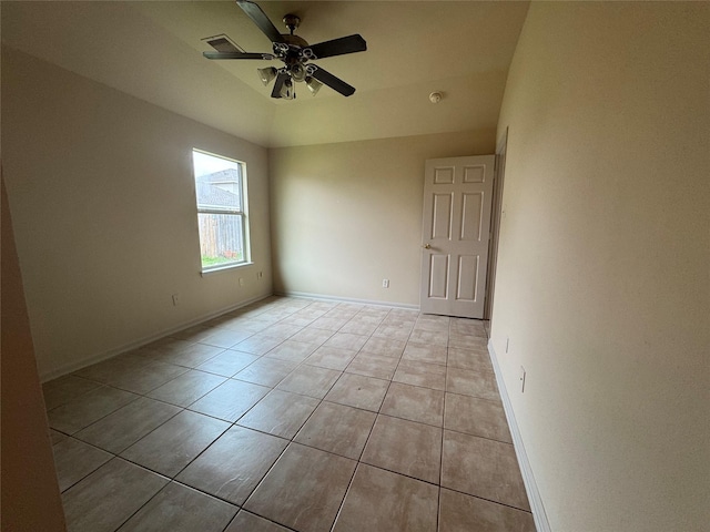 tiled empty room featuring ceiling fan