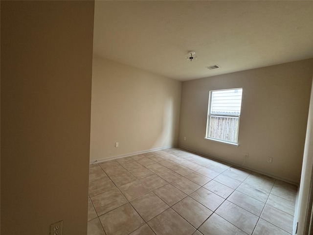 unfurnished room featuring light tile patterned floors