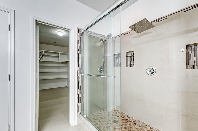 bathroom with a shower with door