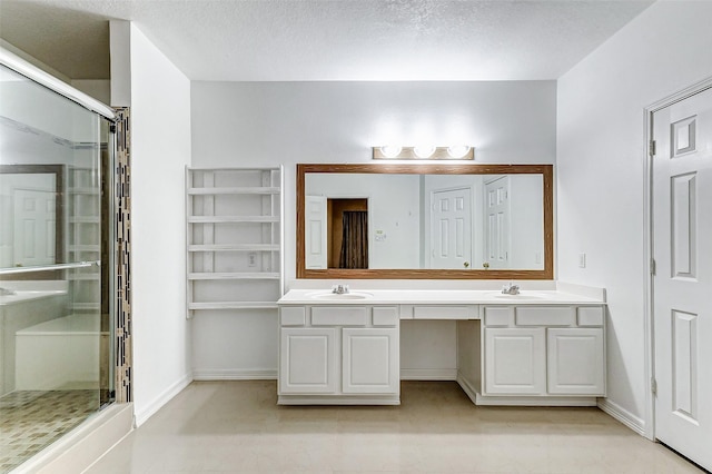 bathroom with walk in shower, vanity, and a textured ceiling