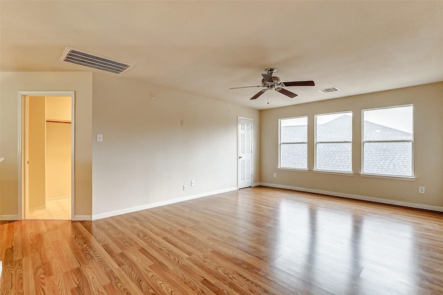 empty room featuring ceiling fan and light hardwood / wood-style flooring