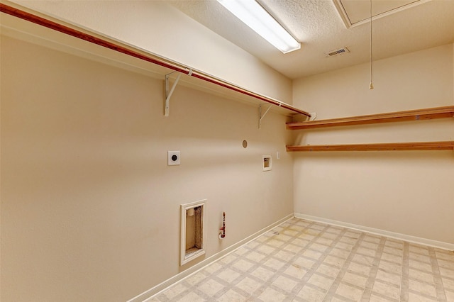 clothes washing area featuring hookup for a gas dryer, hookup for a washing machine, hookup for an electric dryer, and a textured ceiling