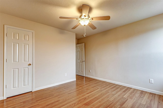 empty room featuring light hardwood / wood-style flooring and ceiling fan