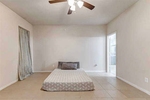 tiled bedroom featuring ceiling fan