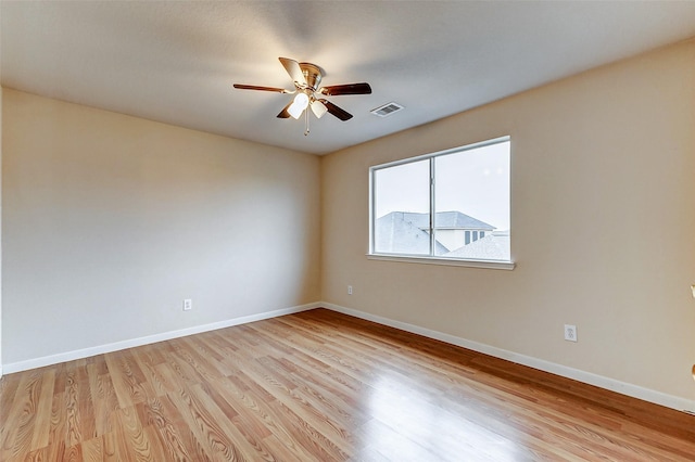 empty room featuring ceiling fan and light hardwood / wood-style floors