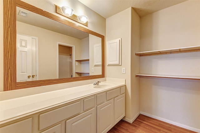 bathroom featuring vanity and wood-type flooring