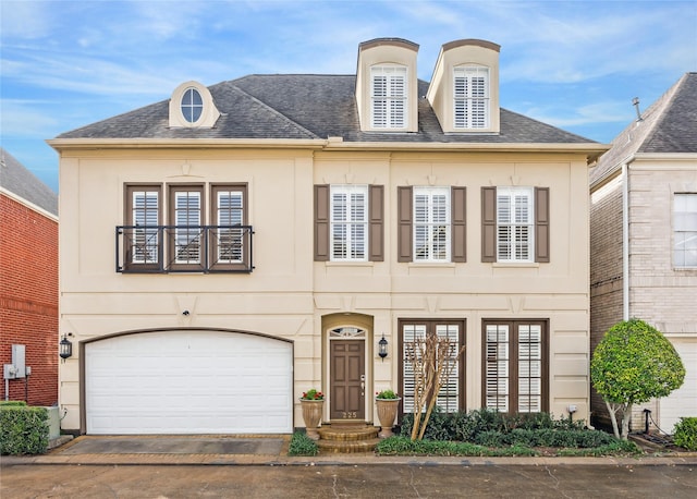 french country inspired facade featuring a garage