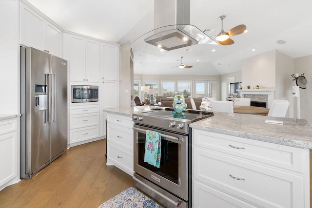 kitchen featuring white cabinetry, appliances with stainless steel finishes, vaulted ceiling, and ceiling fan