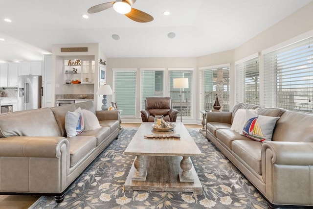 living room featuring dark hardwood / wood-style floors and ceiling fan