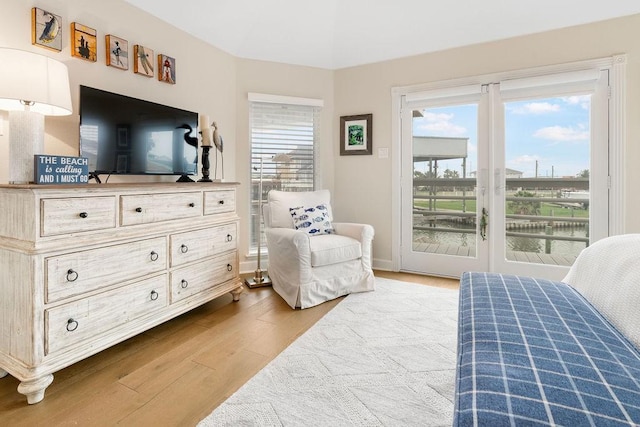 bedroom with hardwood / wood-style flooring and access to outside