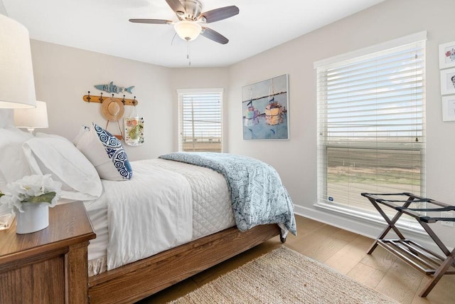 bedroom with hardwood / wood-style flooring and ceiling fan