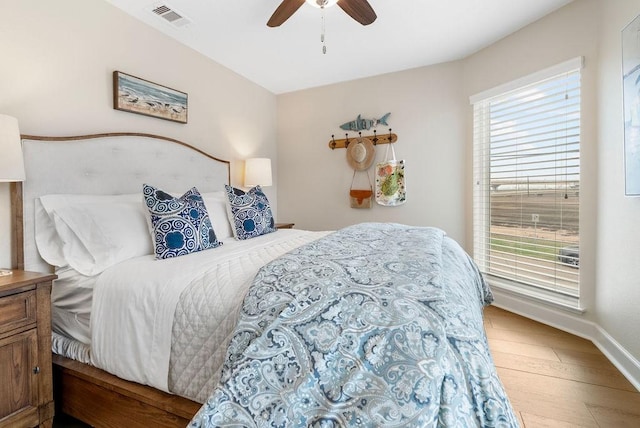 bedroom with ceiling fan and wood-type flooring