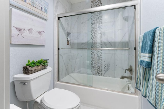 bathroom featuring toilet and enclosed tub / shower combo