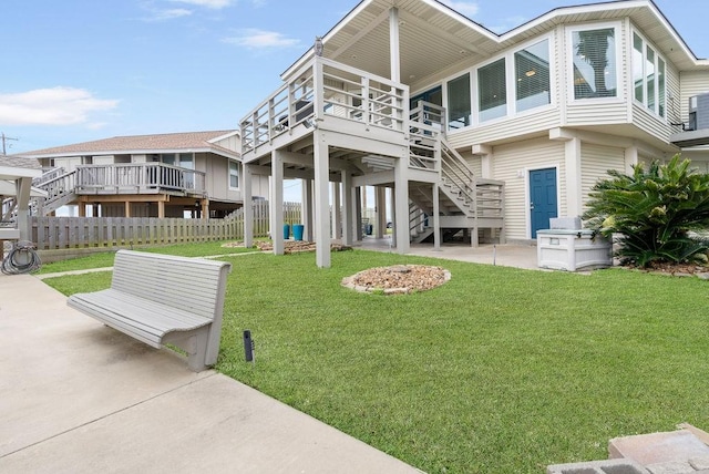 rear view of house featuring a yard and a patio