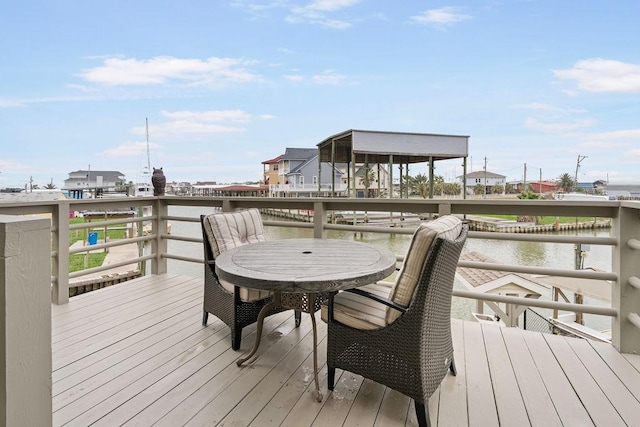 wooden terrace featuring a water view