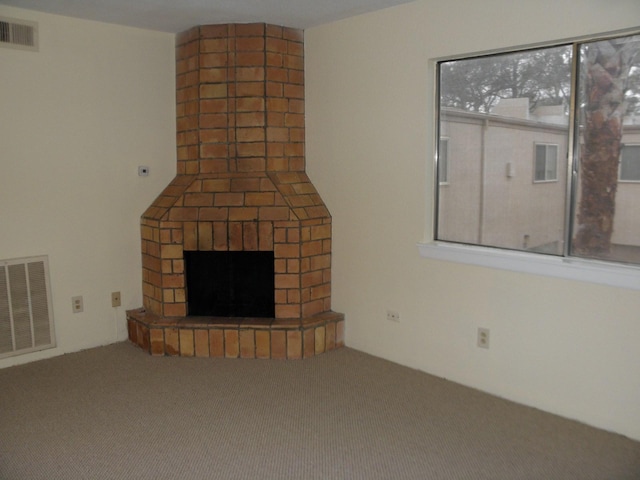 unfurnished living room featuring a fireplace and carpet floors