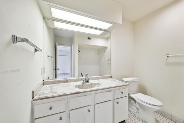 bathroom featuring tile patterned floors, vanity, and toilet