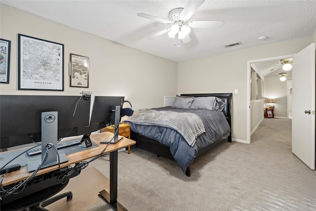 carpeted bedroom with ceiling fan and a textured ceiling