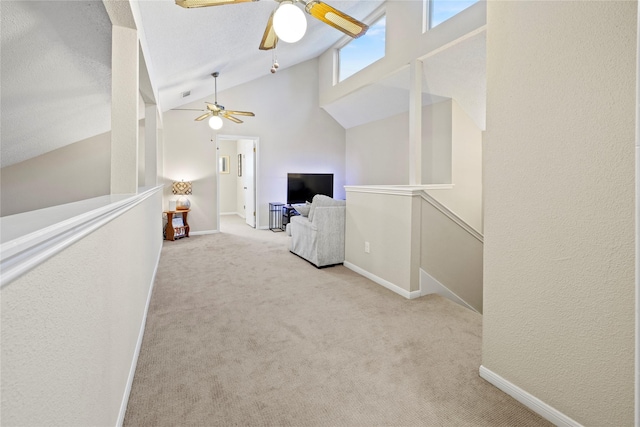 interior space with light carpet and high vaulted ceiling