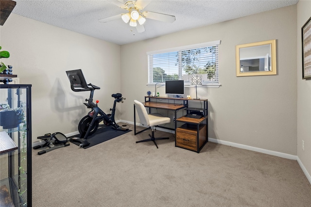 carpeted office with ceiling fan and a textured ceiling