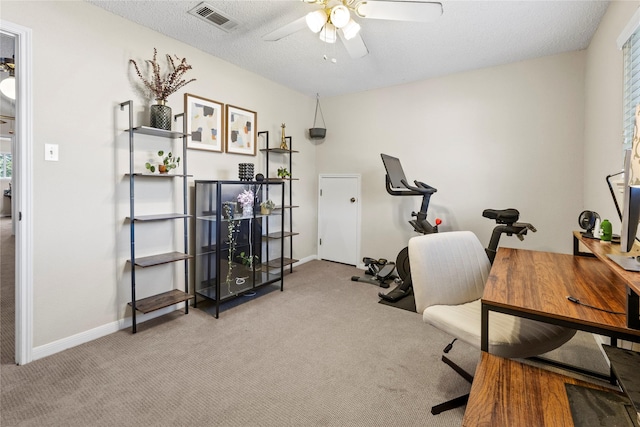 office area featuring light carpet, a textured ceiling, and ceiling fan