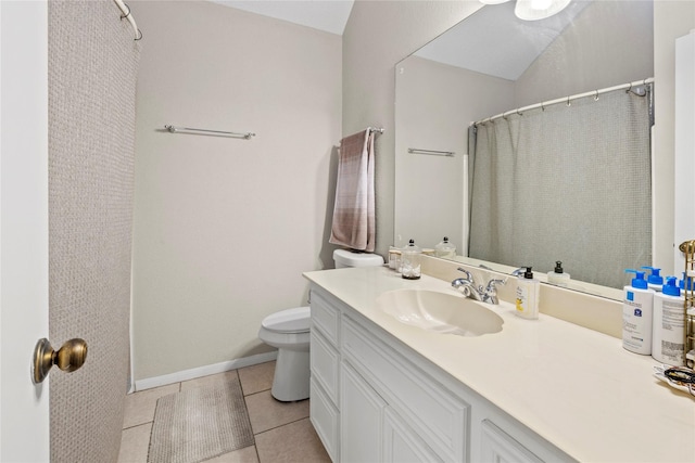 bathroom with vanity, tile patterned floors, and toilet